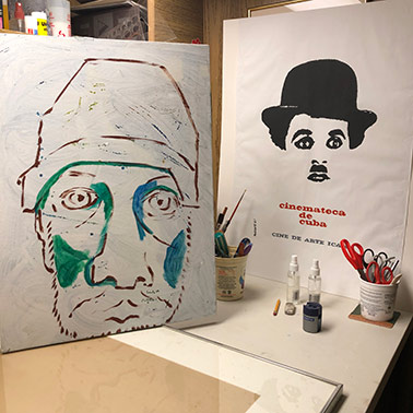 studio photo of Self with Badge painting on the table with Charlie Chaplin